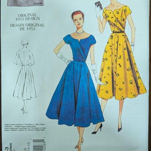May include: Vogue Vintage Model sewing pattern V1043 from 1953. The pattern features illustrations of two dresses: a blue dress with a V-neck and a yellow dress with a floral pattern. The pattern includes the text "ORIGINAL 1953 DESIGN".