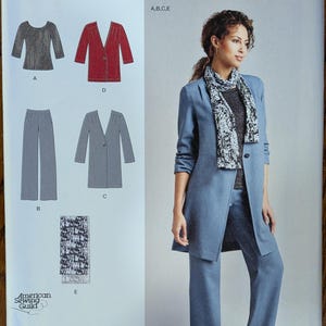 May include: Simplicity sewing pattern 1073 for a jacket, top, pants, and scarf. The envelope displays technical illustrations of the garments in gray, red, and black, alongside a photograph of a blue jacket, pants, and a black and white patterned scarf.