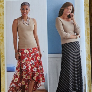May include: A sewing pattern for two skirts, one with a floral print and the other with black and white stripes. The pattern is from Butterick and is size A5 (6-8-10-12).