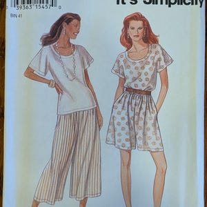 May include: A Simplicity sewing pattern envelope 9007, size A 8-18, featuring illustrations of two outfits. One shows a white short-sleeved top with striped culottes, the other a patterned short-sleeved top with matching shorts and a brown belt.