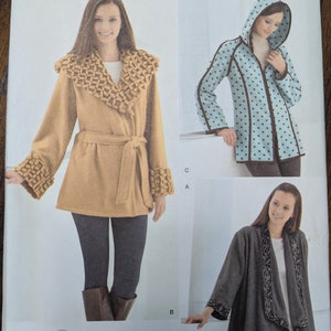 May include: A sewing pattern for three different jackets. The first jacket is a brown wrap jacket with a braided collar and cuffs. The second jacket is a blue and white polka dot jacket with a hood and a zipper closure. The third jacket is a gray wrap jacket with a black floral trim.