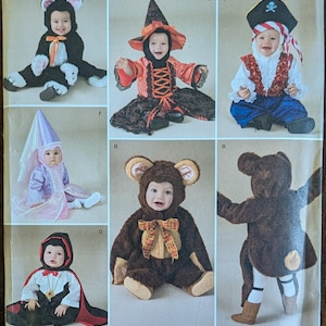 May include: Simplicity pattern featuring baby costumes. The image shows various costumes, including a cat, witch, pirate, princess, monkey, bear, and Little Red Riding Hood. The pattern includes sizes XS, S, M, and L.