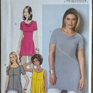 May include: Butterick B6058 sewing pattern featuring various tunic designs. The pattern includes illustrations of tunics in solid pink, striped black and white, and yellow. The pattern size is E5 (14-16-18-20-22).