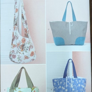 May include: Simplicity sewing pattern S9304 featuring four different tote bag designs. The bags showcase various fabrics, including floral prints, gingham, and botanical patterns. Each bag has unique handle and trim details.