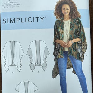 May include: Simplicity sewing pattern S8419 for a draped jacket. The pattern includes diagrams of the jacket design and the text "AMERICAN SEWING GUILD" and "SIMPLICITY". The model is wearing a similar jacket.