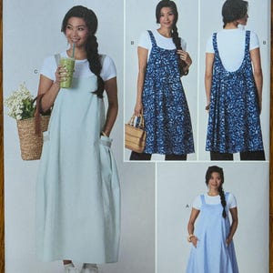 May include: Simplicity sewing pattern S3294 for a sleeveless jumper dress with a scoop neckline and side pockets. The pattern includes three variations: a solid light blue floor-length dress, a blue leaf-print knee-length dress, and a solid light blue midi dress.