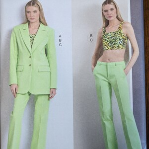 May include: Vogue Patterns sewing pattern R11849 for sizes B5 (8-10-12-14-16). The pattern includes instructions for a green blazer and matching pants, and a separate green top with a leopard print.
