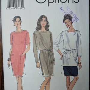 May include: A sewing pattern for a dress with three different styles. The pattern is for sizes 14-16-18. The pattern is called Vogue Easy Options.