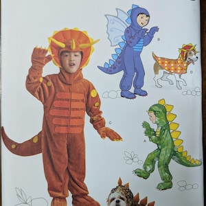 May include: A Simplicity sewing pattern for children's and pet costumes. The pattern includes instructions for making a triceratops, a dragon, a stegosaurus, and a dog costume. The pattern is for sizes 3-8.