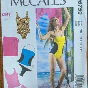 May include: McCall's M6759 sewing pattern envelope for knit swimwear and cover-ups. The front displays illustrations of a leopard print one-piece, a pink wrap skirt, a blue and black tankini, and a pink tank top with matching bikini bottoms.