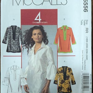 May include: A McCall's M5556 sewing pattern envelope featuring four variations of a tunic top. The cover displays a white tunic with three-quarter length sleeves, alongside illustrations of tunics with zebra print, orange and green, and floral patterns.