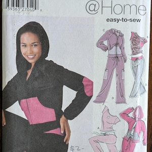 May include: Simplicity @ Home sewing pattern featuring a woman in a black and pink tracksuit. The pattern includes illustrations of various tracksuit styles. The text "easy-to-sew" is visible.