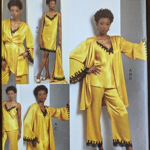 May include: Vogue sewing pattern number V1962 for sizes 16-18-20-22-24. The pattern includes instructions for making a yellow satin robe, pants, and a slip with black lace trim.