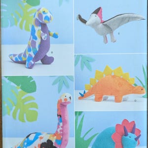 May include: Simplicity sewing pattern featuring various dinosaur plushies. The pattern includes a Tyrannosaurus Rex, a Pterodactyl, a Stegosaurus, a Brachiosaurus, and a Triceratops. The pattern is one size and easy-to-sew.