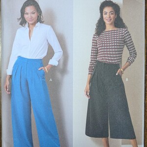 May include: A sewing pattern from Butterick, featuring two women modeling different outfits. One wears a white shirt and blue pants, the other a patterned top and gray culottes. The pattern number is R12056, with sizes Y5 (18-20-22-24-26).
