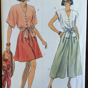 May include: Vintage Very Easy Very Vogue sewing pattern 8069. The pattern features illustrations of two women in summer outfits. One wears a peach-colored top and skirt, the other a white top and green pants. The pattern size is 6-8-10.