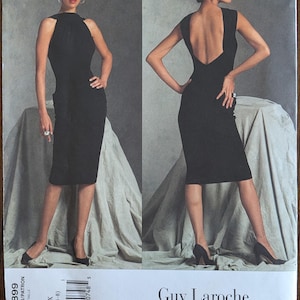 May include: A black dress pattern by Guy Laroche, V2899, featuring a sleeveless, knee-length design with a high neckline and a low back. The pattern includes sizes 4-6-8. The Vogue Paris Original pattern is shown on a model.