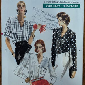 May include: A Very Easy Very Vogue sewing pattern envelope 7129 for sizes 12-14-16. The front features illustrations of three blouses: a white grid-patterned top, a solid light-colored top, and a black top with white polka dots.