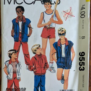 May include: A McCall's 9553 sewing pattern envelope featuring illustrations of various athletic outfits including sleeveless zip-up vests, track pants, shorts, and a hooded jacket. The text includes the brand name, pattern number 9553, and size 14-16.