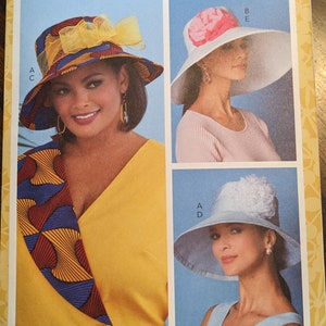May include: A sewing pattern for three different styles of hats. The hats are all made of fabric and have a variety of embellishments, including flowers, bows, and ribbons. The pattern is from Butterick and the pattern number is B6741. All sizes are included.