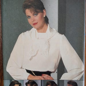 May include: Butterick sewing pattern 6222 for sizes 8-10-12. The envelope features a white long-sleeved blouse with a high neckline and a decorative lace-trimmed scarf collar. Additional variations show different lace neck details and collar styles.