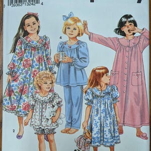 May include: A Simplicity sewing pattern envelope 8093 in size HH (3-6) featuring illustrations of five different sleepwear designs including floral nightgowns, a blue pajama set, and a long pink button-down robe with heart-shaped pocket details.