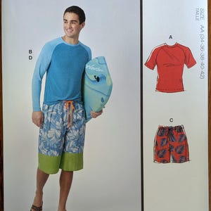 May include: McCall's M8517 sewing pattern envelope featuring a blue raglan sleeve shirt and board shorts with a leaf print and green hem. Includes illustrations for a red short-sleeve shirt and red leaf-print shorts with an orange drawstring.