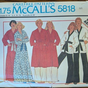 May include: A vintage McCall's 5818 sewing pattern envelope for a robe, jacket, and pants in size large. The front features illustrations of people wearing these garments in red, blue floral, and white with black trim. Text includes Carefree Patterns.