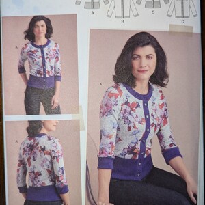 May include: A sewing pattern for a banded cardigan with a floral print. The pattern includes four different styles, labeled A, B, C, and D. The pattern is for sizes US 14-22, Talla Euro 40-48, and Taille FR 42-50. The pattern is called "The Banded Cardi" and is Simplicity pattern number 8951.