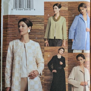 May include: A Vogue Basic Design sewing pattern envelope, number 7714, for sizes 20, 22, and 24. The front displays five variations of jackets and coats in different colors and textures, including a white and tan checkered long jacket.