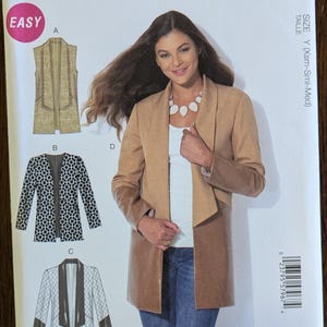 May include: McCall's sewing pattern M7332, featuring a woman wearing a tan jacket. The pattern includes multiple view options with easy instructions. The size is Y (Xsm-Sml-Med). Designed and printed in the USA.