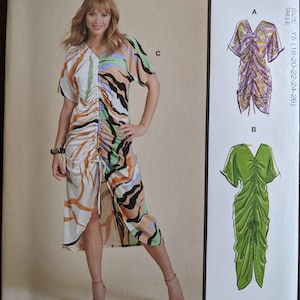 May include: A sewing pattern for a dress with three different views. The dress has a gathered bodice and a flowing skirt. The pattern includes instructions for making the dress in sizes Y5 (18-20-22-24-26).
