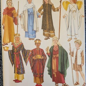 May include: A Simplicity sewing pattern envelope 4797 featuring illustrations of eight historical and nativity-themed costumes. The designs include robes, tunics, a crown, an angel with wings, and a shepherd's staff, displayed in various colors.
