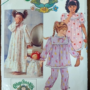 May include: Vintage Butterick sewing pattern for Cabbage Patch Kids outfits, size 4-5. The pattern features illustrations of children's pajamas and nightgowns with floral and heart patterns. Includes iron-on transfers. The pattern is in English.