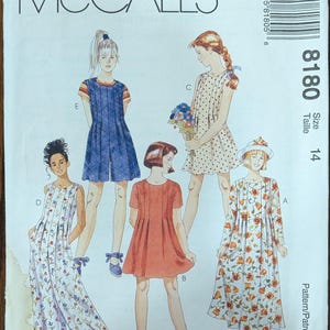 May include: McCall's sewing pattern featuring illustrations of various dresses and a jumpsuit. The pattern number is 8180, size 14. The cover displays several dress designs, including a floral print dress and a polka dot dress.