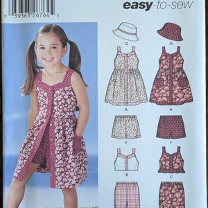 May include: Simplicity sewing pattern 5540 for girls' clothing. The pattern includes options for dresses, shorts, tops, and pants. The cover features a young girl wearing a floral print dress. The pattern sizes range from 3 to 8.