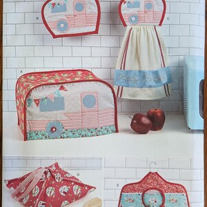 May include: A Simplicity S9412 sewing pattern envelope featuring kitchen accessories with camper motifs. The designs include a toaster cover, a hanging towel, a pot holder, a fabric wrap, and a hanger cover in red, blue, and white fabrics.
