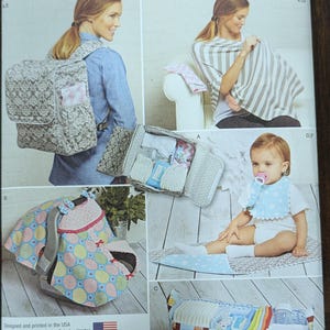May include: A sewing pattern for a baby carrier, a car seat cover, a nursing cover, a diaper bag, and a bib. The pattern is from Simplicity and is for one size. The pattern is designed and printed in the USA.
