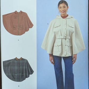 May include: Simplicity sewing pattern R12173 featuring cape designs. The pattern includes a hooded cape with a belt and pockets, and a second cape with a collar. The size range is S-XL. Designed and printed in the USA.