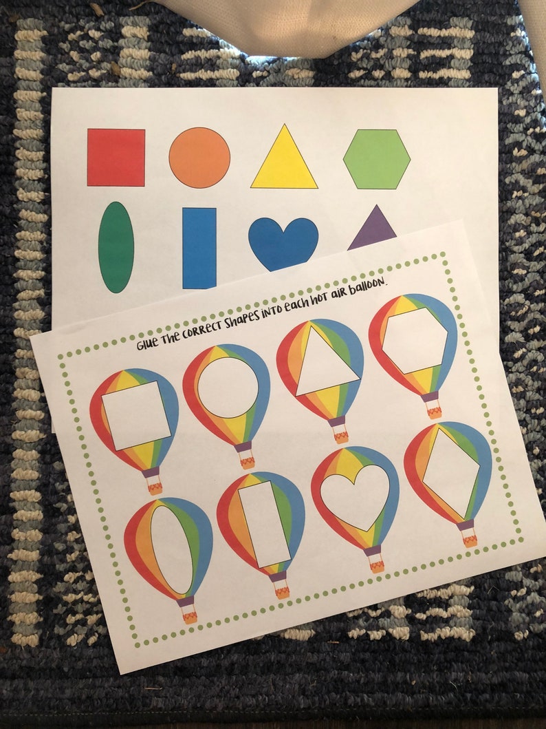May include: A printable worksheet with a set of colorful shapes and a set of hot air balloons with blank spaces for the shapes. The text "Give the correct shapes into each hot air balloon." is at the top of the page.