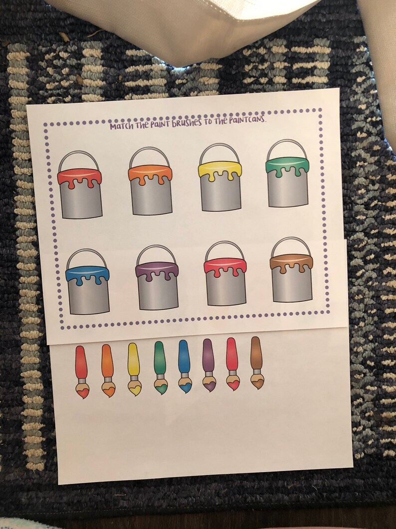 May include: A printable worksheet with the text "Match the paint brushes to the paint cans."  The worksheet has eight paint cans in two rows of four. The paint cans are filled with different colors of paint: orange, yellow, green, purple, red, brown, blue, and light blue.  Below the paint cans are eight paint brushes in a row, each with a different color of paint on the brush: orange, yellow, green, blue, purple, red, brown, and light blue.
