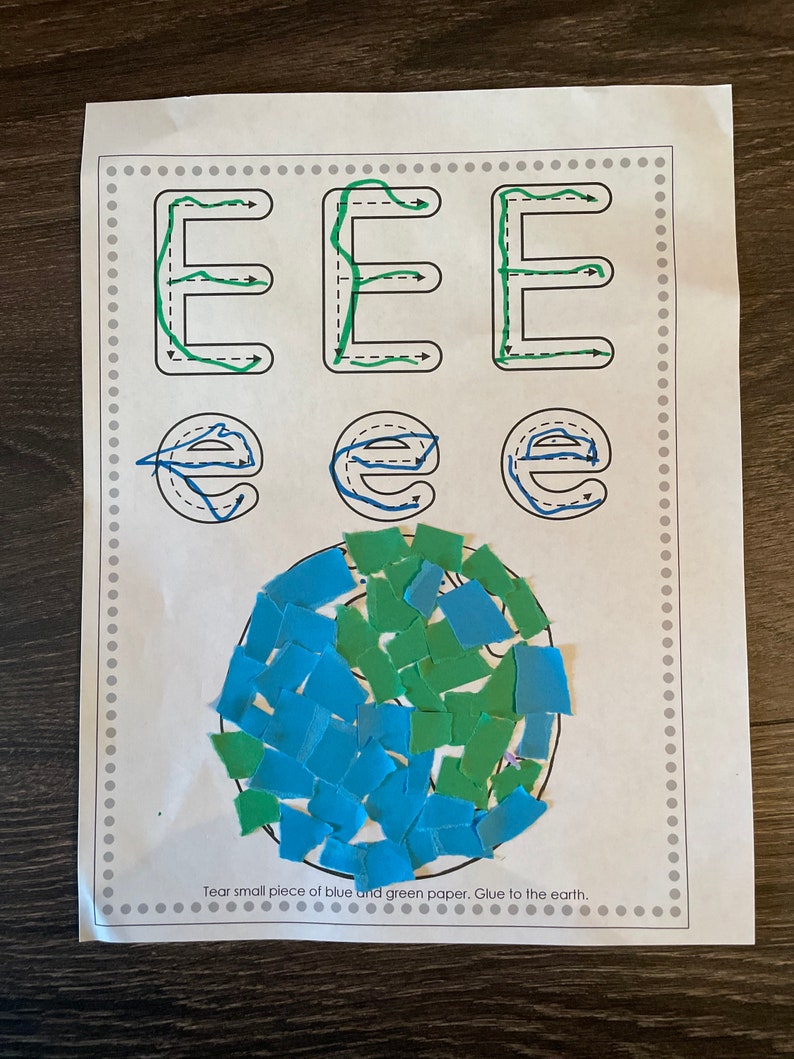 May include: A printable worksheet with instructions to tear small pieces of blue and green paper and glue them to the earth. The worksheet also includes practice tracing the letter 'E' in uppercase and lowercase.