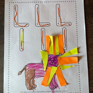 May include: A printable worksheet with the letter L traced in orange. A lion is drawn with a mane made of orange and yellow paper strips. The text reads "Cut strips of orange and yellow paper and glue as a mane."