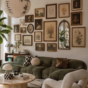 May include: A low-profile olive green tufted sofa with a modular design, featuring a checkered throw pillow, a round cream pillow, and a brown tiger-print pillow. The sofa is positioned in a living room with a gallery wall of framed art and a mirror.