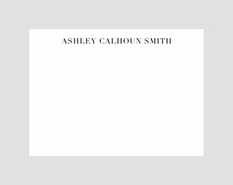 May include: A white card with the name "ASHLEY CALHOUN SMITH" printed in black text at the top.