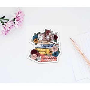 May include: A sticker featuring a stack of colorful books with floral accents. The books have the text "Start with it Bismillah" and "Alhamdulillah" on them.