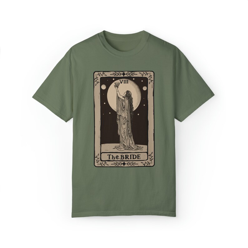 Op de afbeelding: Een groen T-shirt met een vintage tarotkaartontwerp met een vrouw die een kelk vasthoudt. De kaart is gelabeld met "VIII The BRIDE".