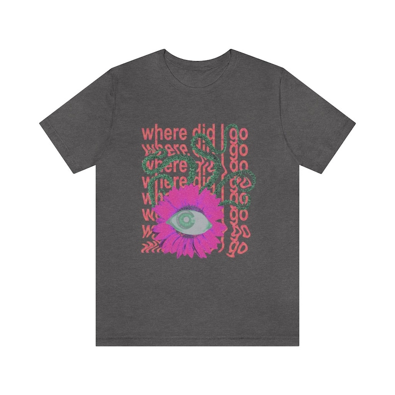 May include: A dark heather grey t-shirt featuring a pink flower with a green eye in the centre. The text "where did I go" is repeated in pink and green around the flower.
