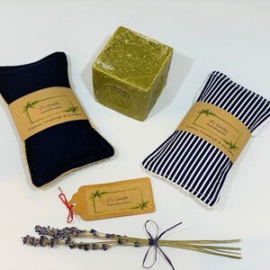 May include: Two blue and white striped kitchen scrubbers with brown paper labels that say "Ci's Crafts handmade Kitchen Utensils & Scrubbies". A green bar of soap and a small brown tag with the text "Ci's Crafts handmade" are also in the image.
