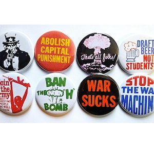 May include: A set of eight circular pin-back buttons featuring various political and social slogans. Designs include Uncle Sam, text reading Abolish Capital Punishment, That's all folks, Draft Beer Not Students, Join the army, Ban the H Bomb, War Sucks, and Stop the War Machine.